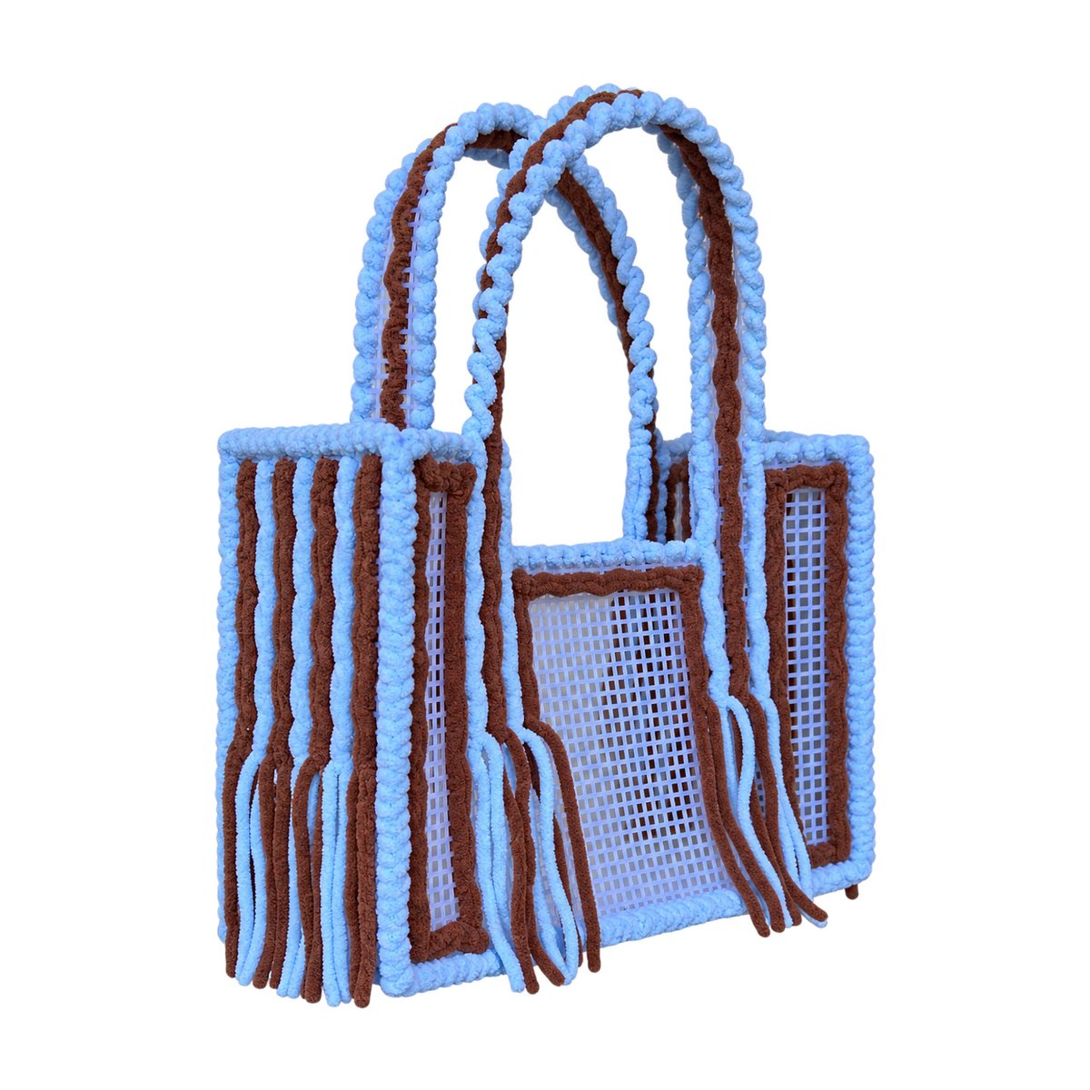 Side view of the Blue Cocoa crochet mesh tote bag showing twin yarn-wrapped handles and fringe
