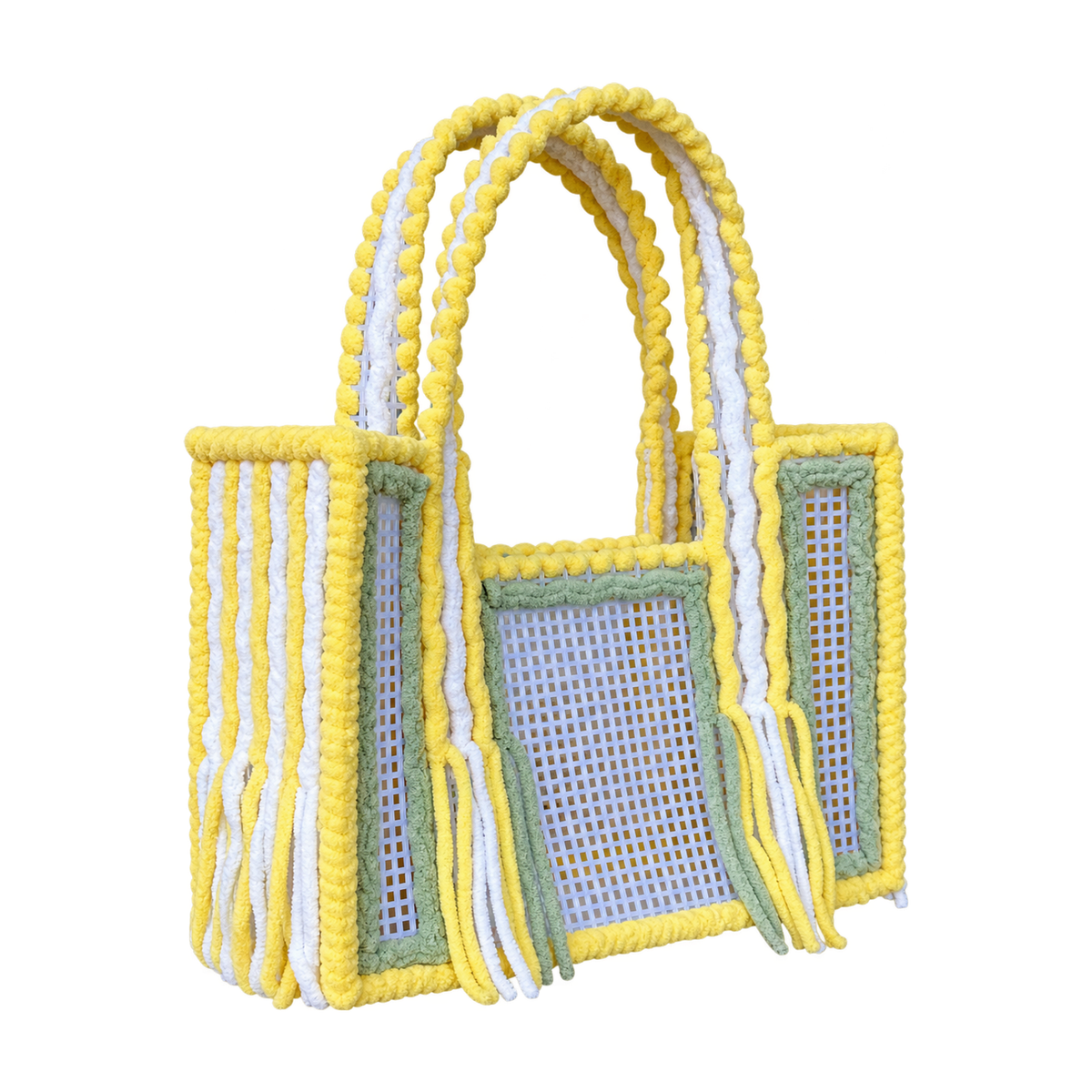 Side view of the Limoncello crochet mesh tote bag showing twin yellow and white yarn-wrapped handles and fringe